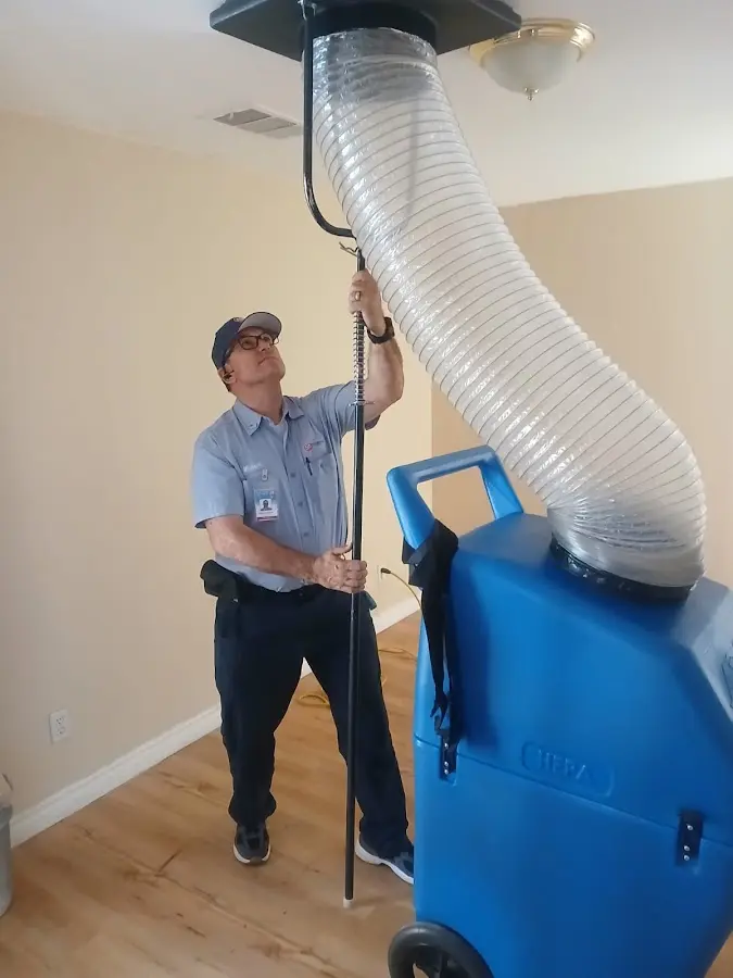 Furnace Tune-Up technician using HEPA equipment in Murrieta